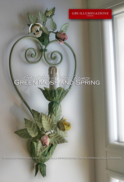 Romantic sconce with forged iron heart and small bouquets of roses and buds. Shades of green moss and spring, roses in pastel colours.