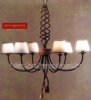 Wrought iron chandelier, rust tempera finish, details in gold patina. Corda Collection